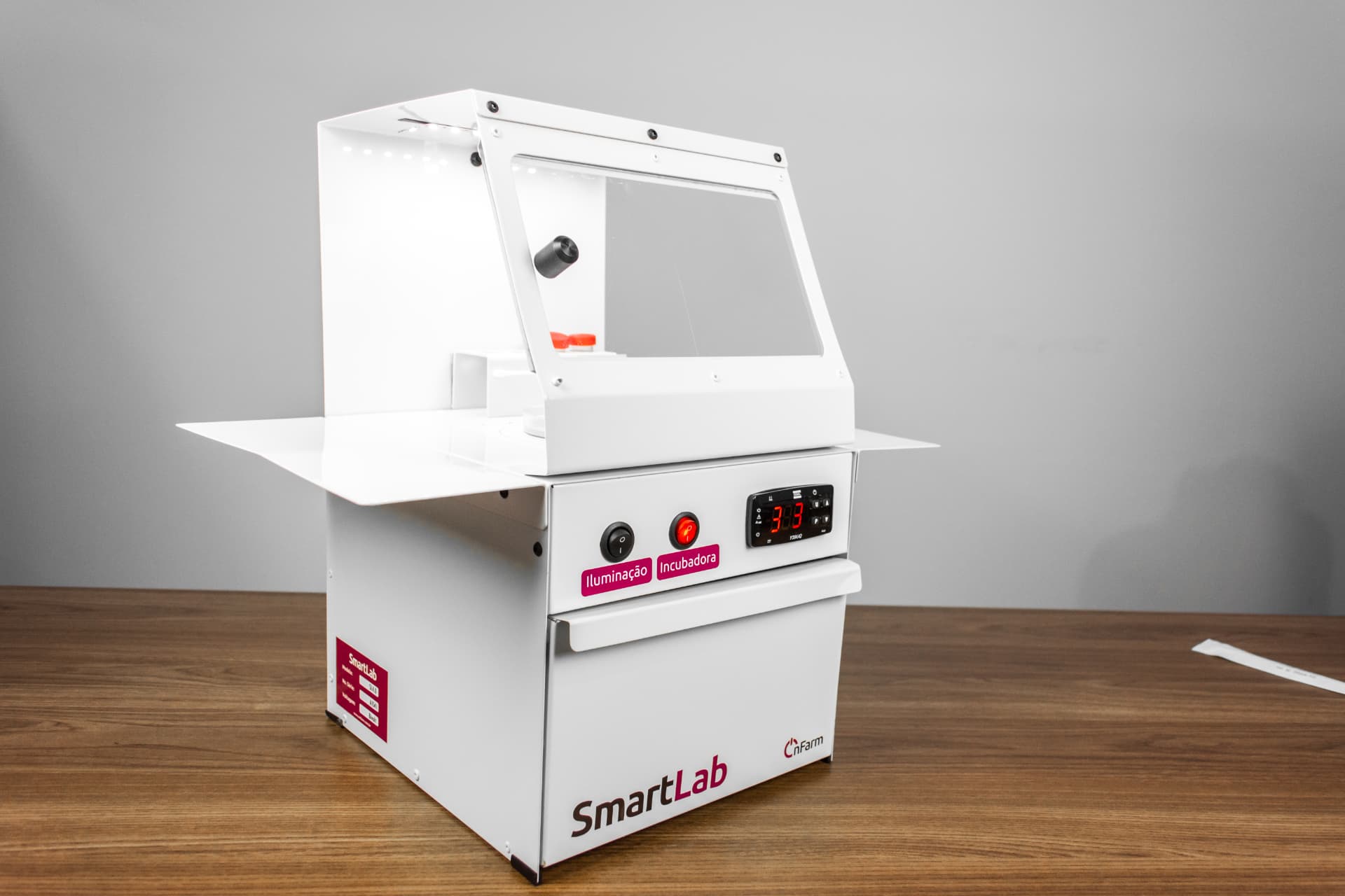 Incubadora SmartLab em bancada, com tampa de vidro, placas em uso e display de temperatura
